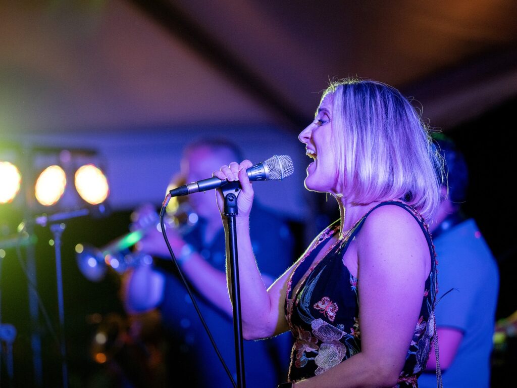 Close up of a female lead singer performing at the National Aviary's Night in the Tropics